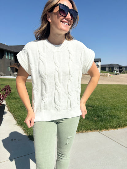 styled view of Kinney ivory cable knit short-sleeved sweater, shown in size S/M