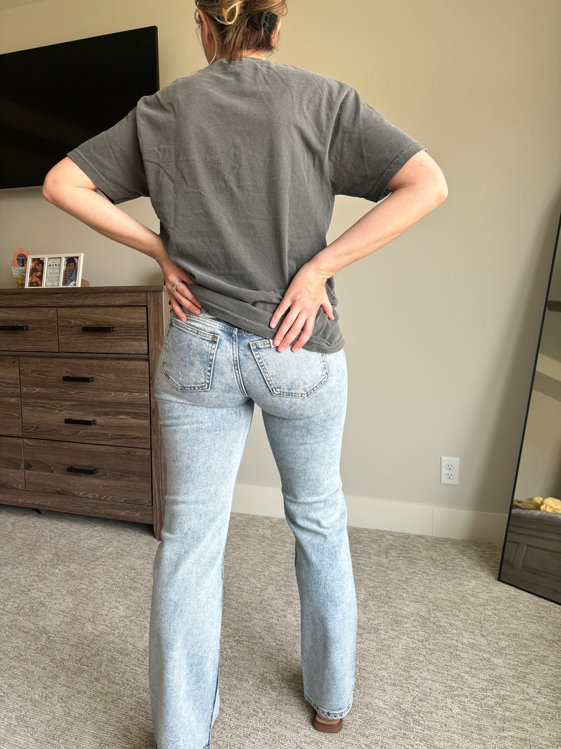 pocket view of Hawthorne light acid wash boot cut jeans, mid-rise, hole-free design, worn by model in true size