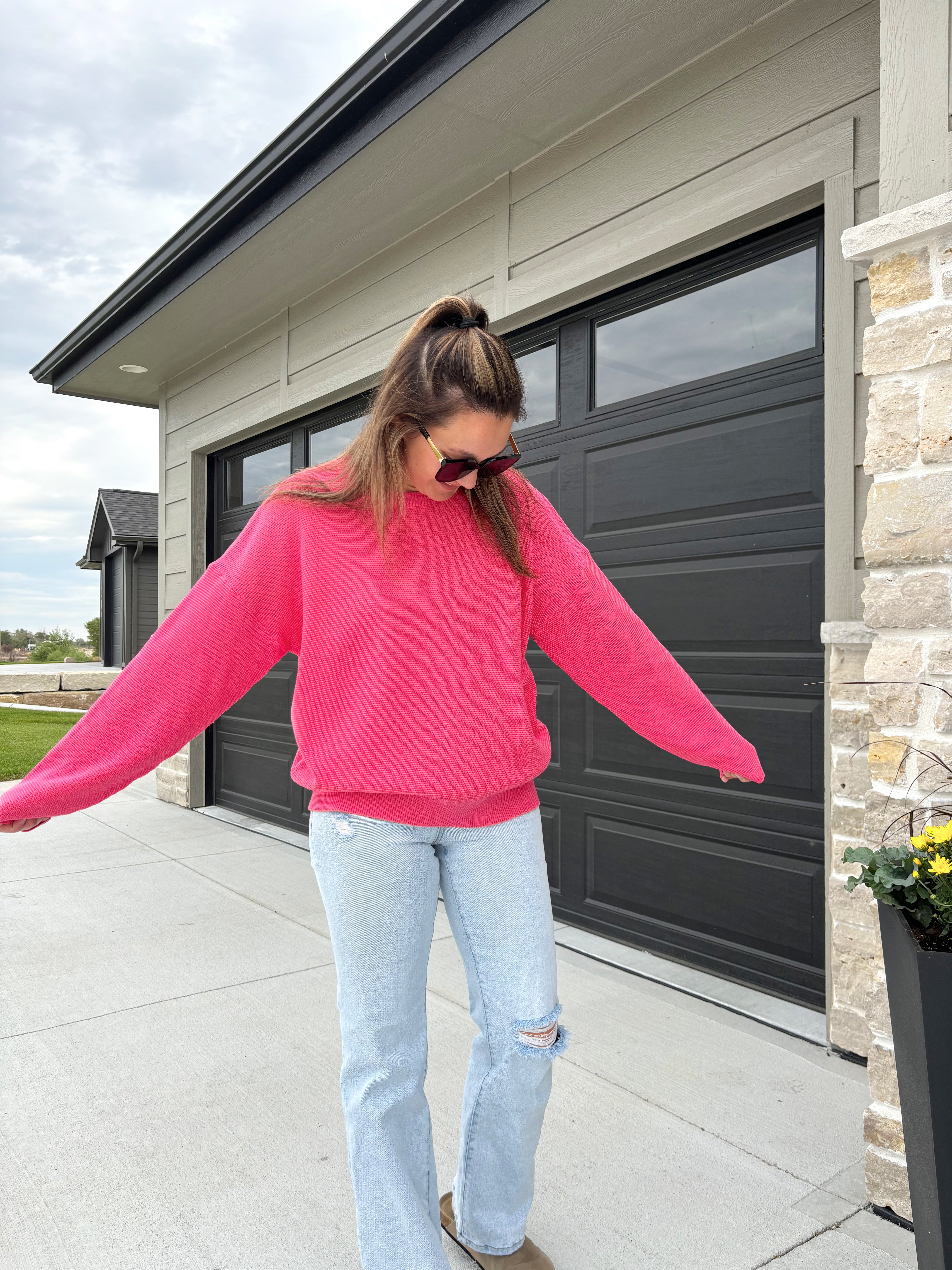 sleeve detail of Hinston two-tone waffle knit sweater in fuchsia and coral, 100% cotton, shown in size medium