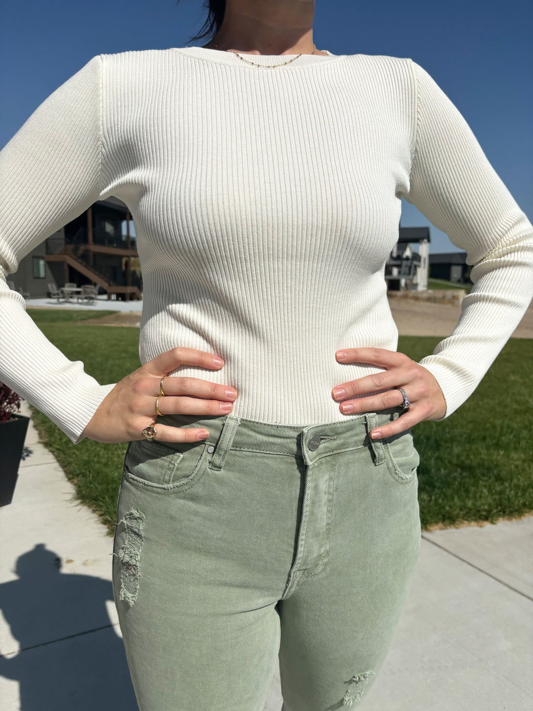 close up detail of Ivory Raymond long sleeve top with round neck and ribbed pattern, shown in size large