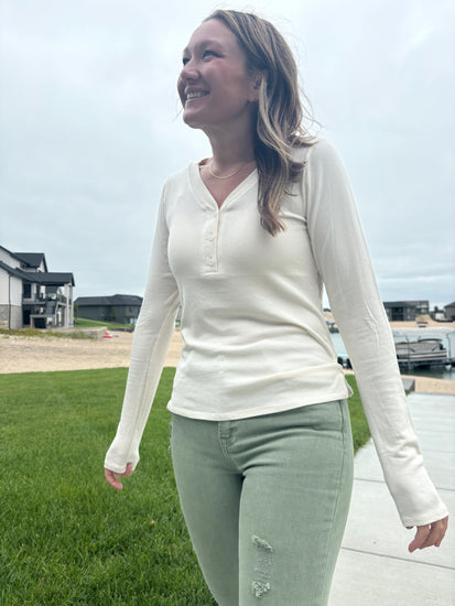 styled view of Nichols cream Henley long sleeve top, ultra-comfortable micro-modal/spandex blend, shown in size medium