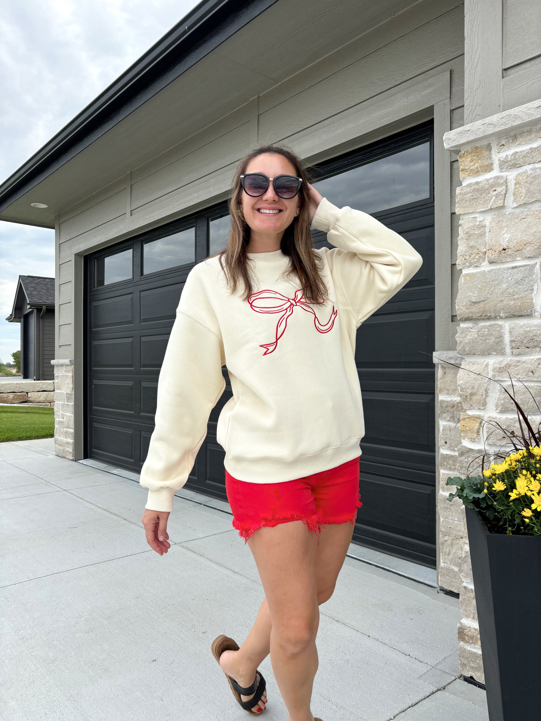 Carlton cream and crimson bow sweater, 100% polyester, shown in size medium