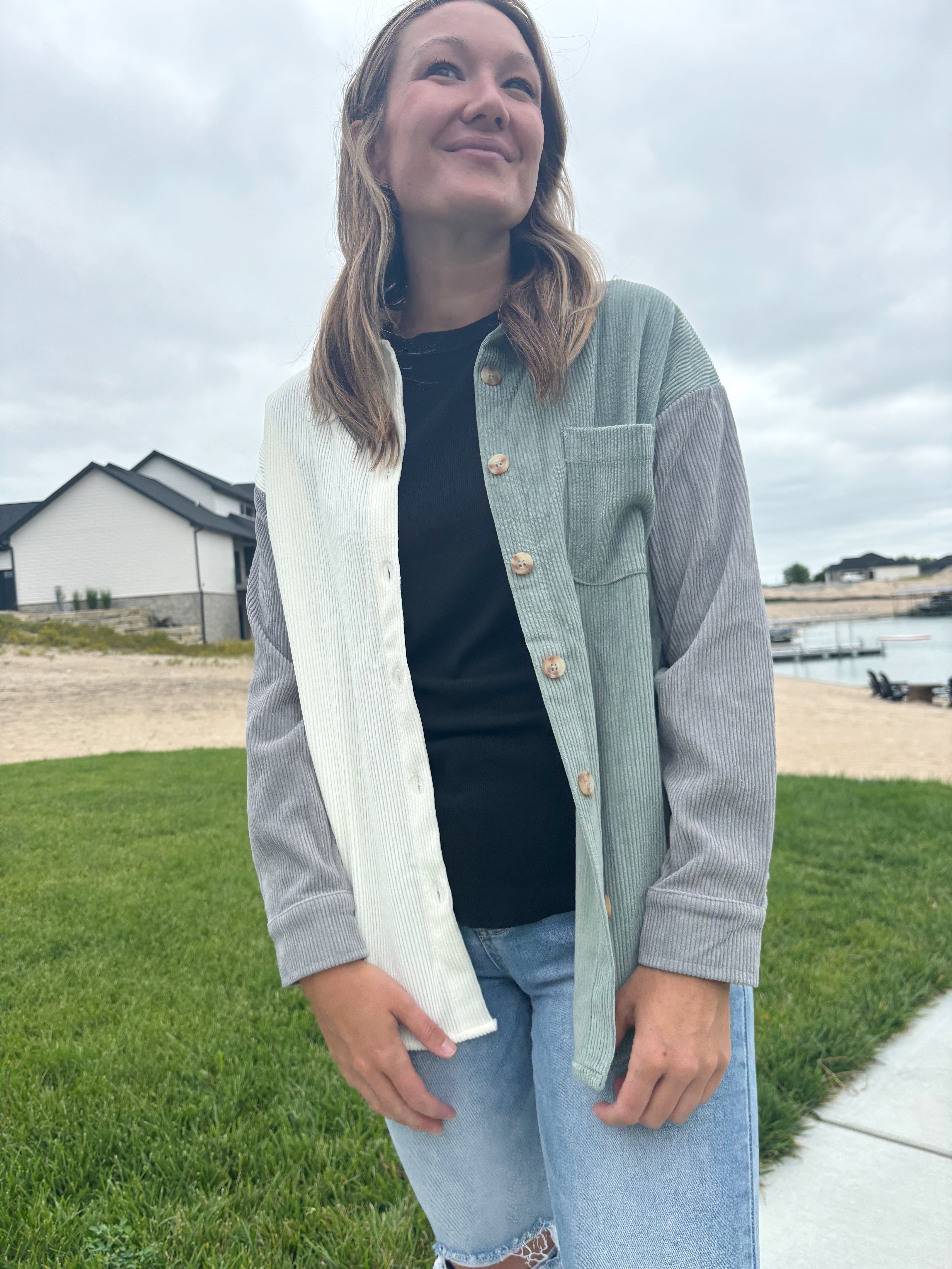 styled view of Bryant colorblock corduroy jacket in off-white, grey, and sage green with collared neckline and button-up, shown in size small