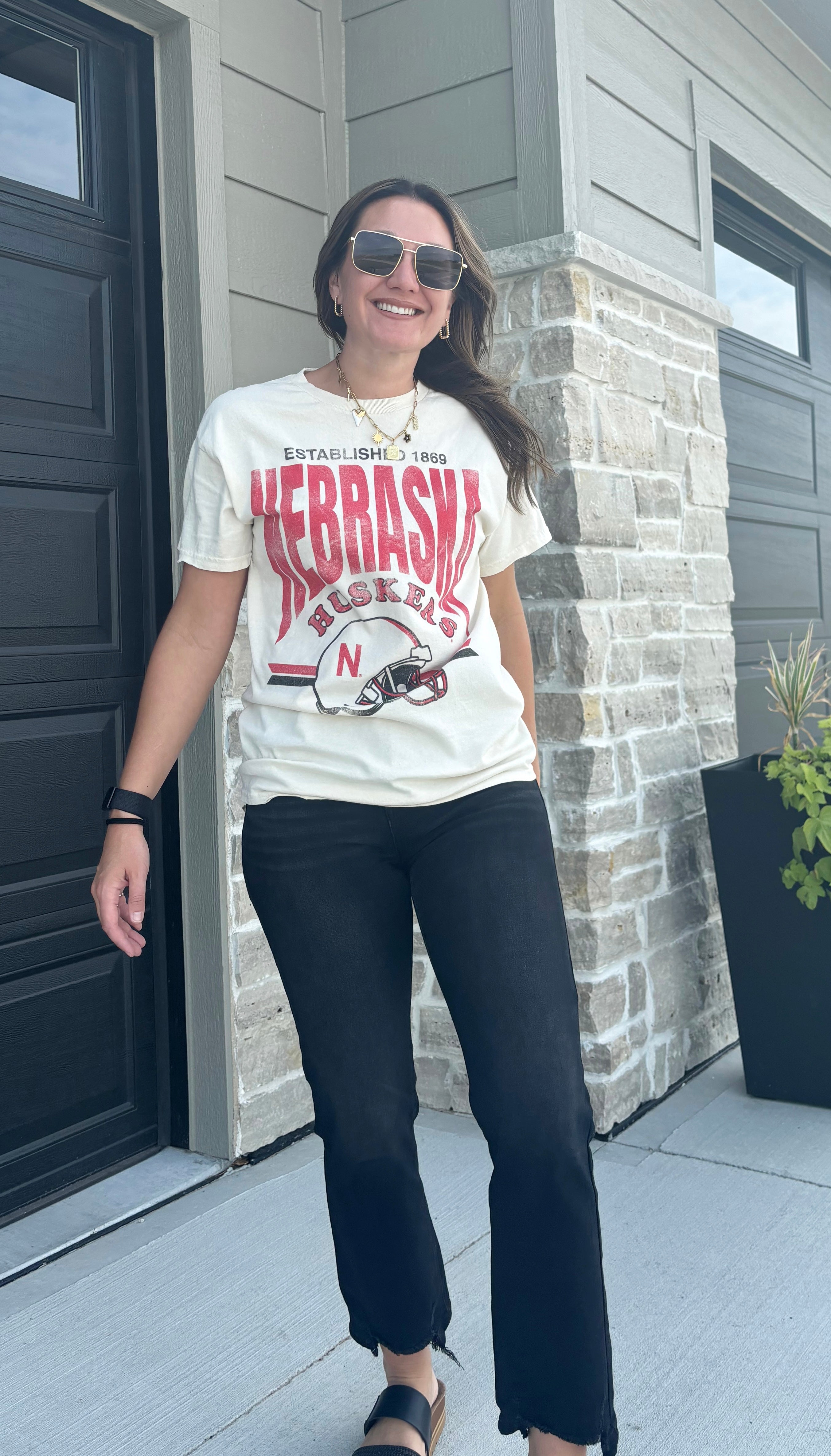 styled view of Nebraska Huskers distressed helmet tee, oversized fit, pre-shrunk 100% cotton, officially licensed, shown in size small