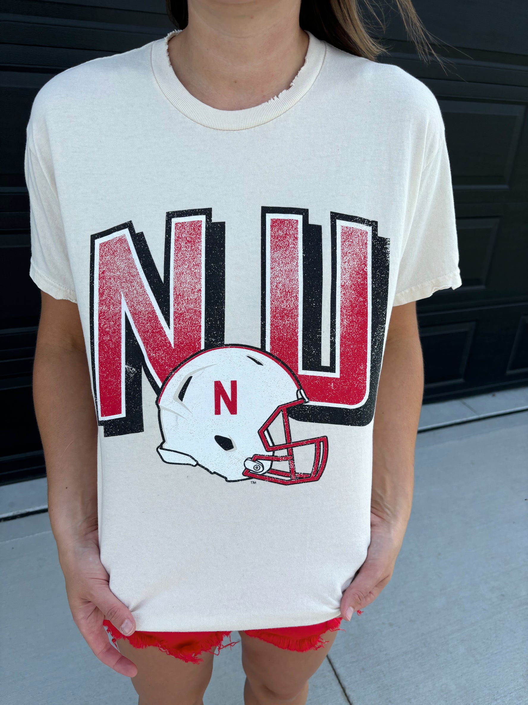 graphic detail of NU distressed tee, oversized fit, pre-shrunk 100% cotton, officially licensed by the University of Nebraska, shown in size small